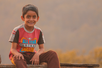 Boy Sitting On Bench
