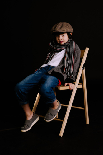 Boy Sitting on Brown Chair Boy Sitting on Brown Chair