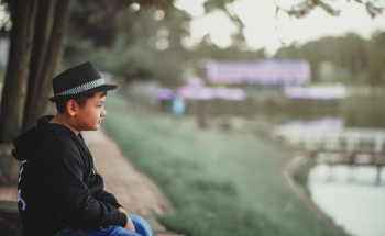 Boy Sitting On Chair 