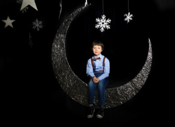 Boy Sitting on Moon Decor