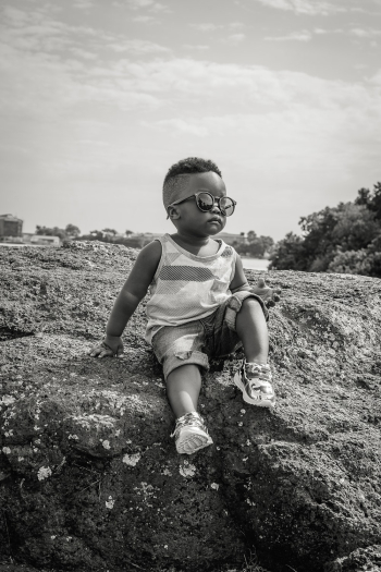 Boy Sitting on Rock