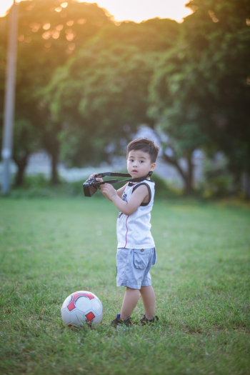 Boy Standing Beside Soccer Ball Boy Standing Beside Soccer Ball