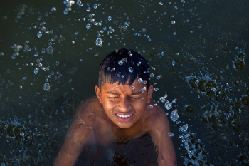 Boy Swimming on Body of Water Boy Swimming on Body of Water
