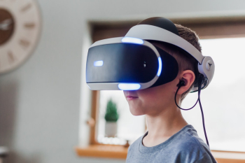 Boy Wearing Black and White Virtual Reality Headset Boy Wearing Black and White Virtual Reality Headset