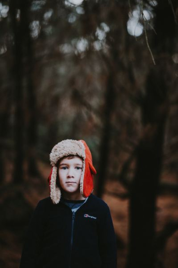 boy wearing red ear pluff boy wearing red ear pluff