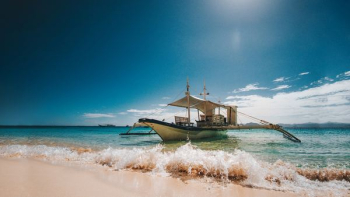 brown and black boat on seashore during daytime brown and black boat on seashore during daytime