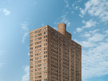 brown apartment-type building brown apartment-type building