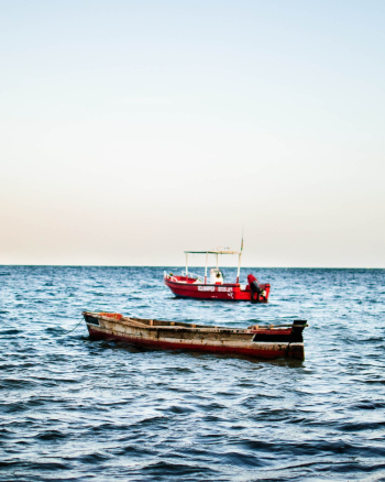 Brown Boat Beside Red Vessel Brown Boat Beside Red Vessel