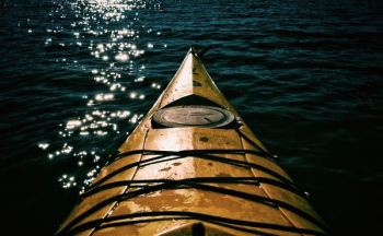 brown boat on water brown boat on water