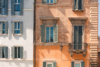 brown building beside white building brown building beside white building