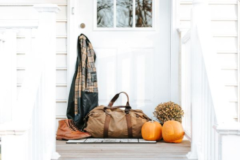 brown duffel bag in front of door brown duffel bag in front of door
