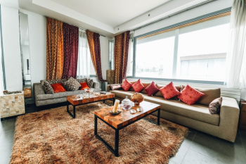 Brown Leather Sofa With Red Pillows Near Windows Brown Leather Sofa With Red Pillows Near Windows