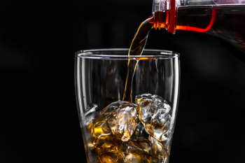 Brown Liquid Pouring on Ice Drinking Glass Brown Liquid Pouring on Ice Drinking Glass