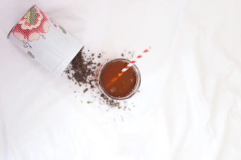 brown liquid with red and white straw brown liquid with red and white straw