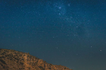 brown mountain under blue and gray sky with stars brown mountain under blue and gray sky with stars