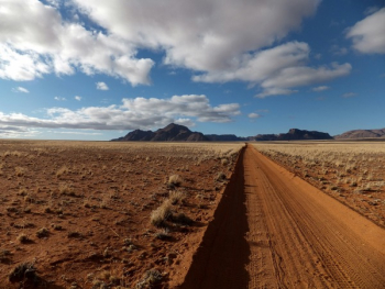 Brown Sandy Field Under Blue and White Cloudy Sky Brown Sandy Field Under Blue and White Cloudy Sky