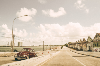Brown Volkswagen Beetle on Asphalt Road Brown Volkswagen Beetle on Asphalt Road