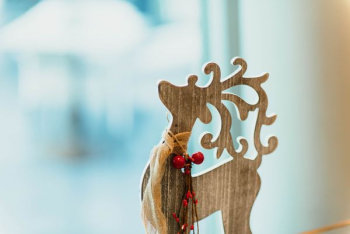 brown wooden carved reindeer decoration on table brown wooden carved reindeer decoration on table