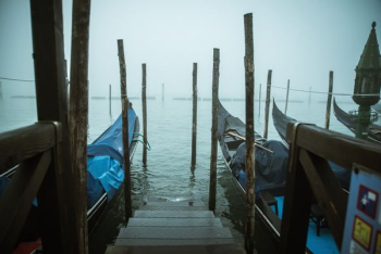 brown wooden ladder beside watercrafts on body of water brown wooden ladder beside watercrafts on body of water