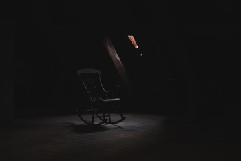 brown wooden rocking chair inside dark room brown wooden rocking chair inside dark room