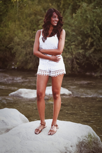Brunette in White Jumper Shorts Standing on Boulder Rock