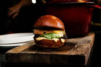 burger on top of brown board burger on top of brown board