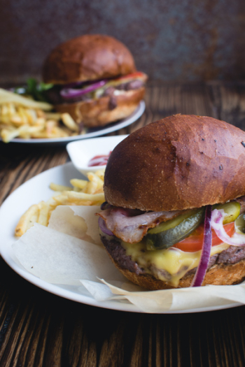 Burger with cheddar cheese, bacon and fries Burger with cheddar cheese, bacon and fries