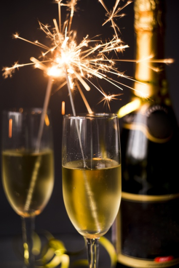 Burning sparkler in champagne glass on dark background Free Photo Burning sparkler in champagne glass on dark background Free Photo
