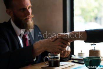 Business agreement handshake at coffee shop Business agreement handshake at coffee shop
