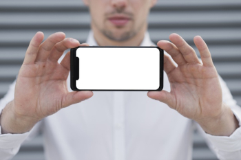 Business man holding iphone mock-up Free Photo