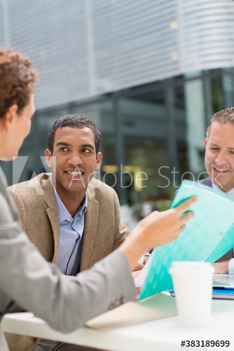 Business people discussing paperwork Business people discussing paperwork