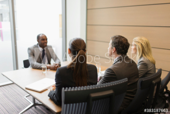 Business people interviewing businessman in conference room Business people interviewing businessman in conference room