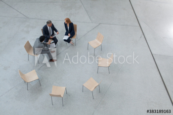 Business people meeting in circle of chairs Business people meeting in circle of chairs