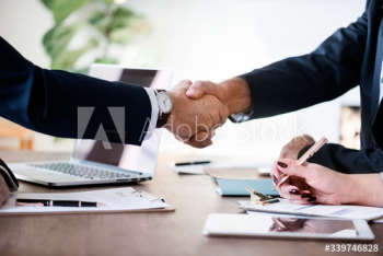 Business people shaking hands together Business people shaking hands together