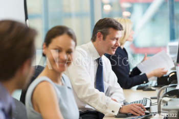 Business people working in open plan office Business people working in open plan office