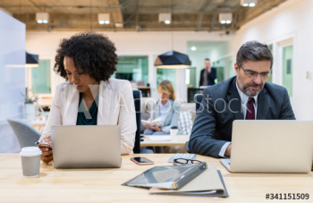 Business people working on digital devices Business people working on digital devices