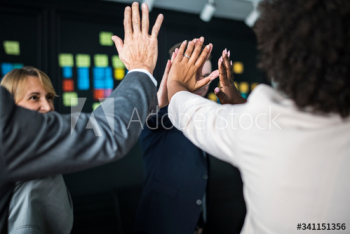 Business team giving a high five Business team giving a high five