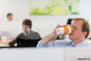 Businessman drinking coffee in office Businessman drinking coffee in office