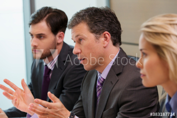 Businessman gesturing and explaining in conference room meeting Businessman gesturing and explaining in conference room meeting