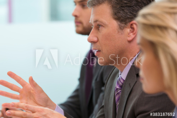 Businessman gesturing and explaining in meeting Businessman gesturing and explaining in meeting