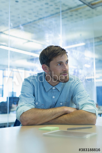 Businessman looking away in office Businessman looking away in office