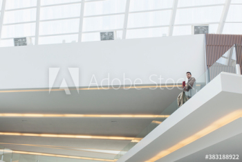 Businessman on modern office atrium balcony Businessman on modern office atrium balcony