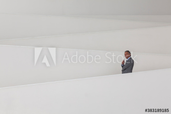 Businessman on modern office ramp Businessman on modern office ramp