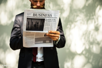 Businessman standing and reading newspaper | Free stock psd mockup - 380037