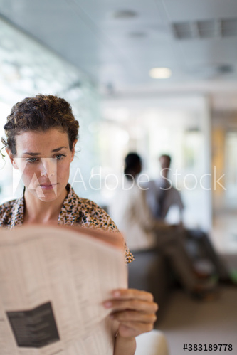 Businesswoman reading newspaper Businesswoman reading newspaper