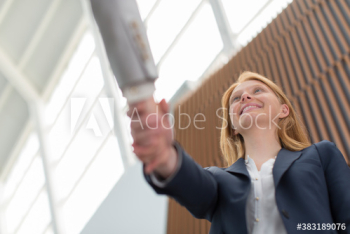 Businesswoman shaking hands with colleague Businesswoman shaking hands with colleague