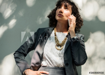 Businesswoman using mobile phone communication technology Businesswoman using mobile phone communication technology