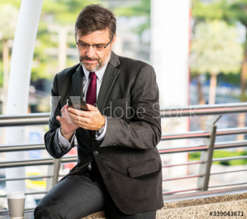 Busy businessman checking his phone Busy businessman checking his phone