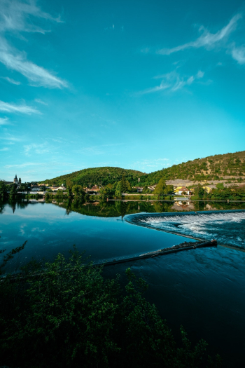 Calm Body of Water Under Blue Sky Calm Body of Water Under Blue Sky