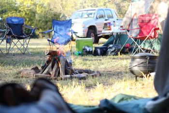 camping chairs in front of bonfire near pickup truck camping chairs in front of bonfire near pickup truck